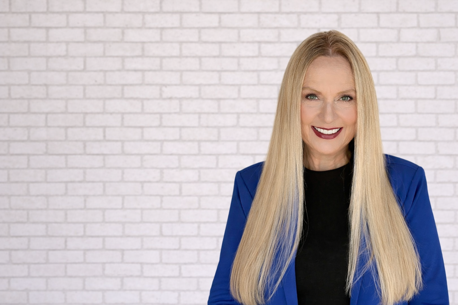 Cynthia L. Clack, Texas family law attorney and author, photographed against a brick wall in Odessa, TX